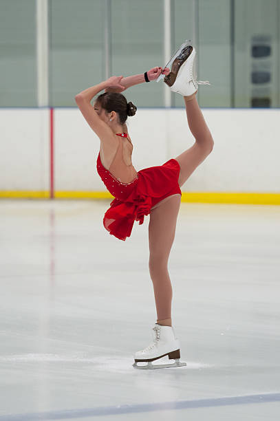 Figure Skater Holds a Pose Figure skater holding a pose. figure skating stock pictures, royalty-free photos & images