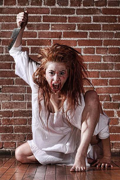 istock Horror Theme With Bleeding Woman With Knife 177036862