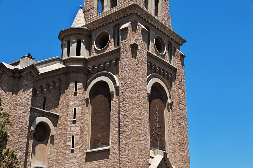 Bell towers of the Basilica of Saint Frances of Assisi along Dolores street in the Mission district of San Francisco.