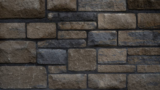 Dark black anthracite beige rustic stone wall texture pattern, privacy protection outdoor garden architecture background