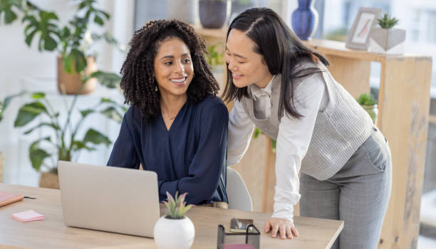 istock Leadership, Asian or manager coaching a worker in online startup or group project in a digital agency. Teamwork, laptop or happy woman helping, talking or speaking of our vision or branding direction 1770374951