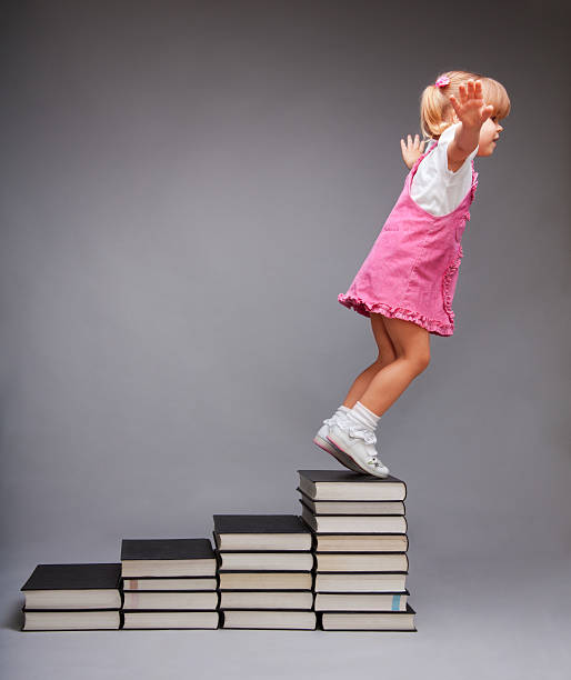 возможности после образования - book child staircase steps стоковые фото и изображения
