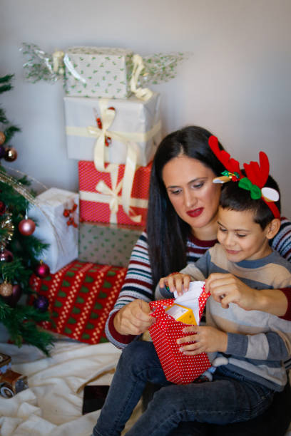 istock Child opens Christmas presents 1770382819
