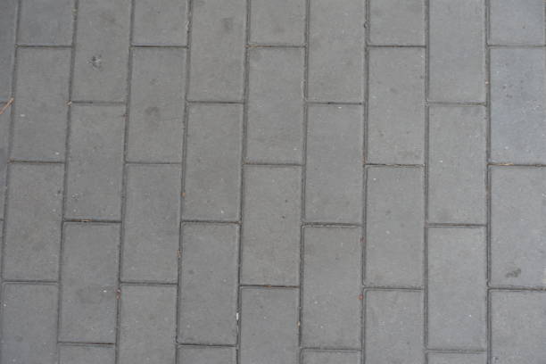 istock Dusty surface of running bond brick like gray concrete pavement 1770392936