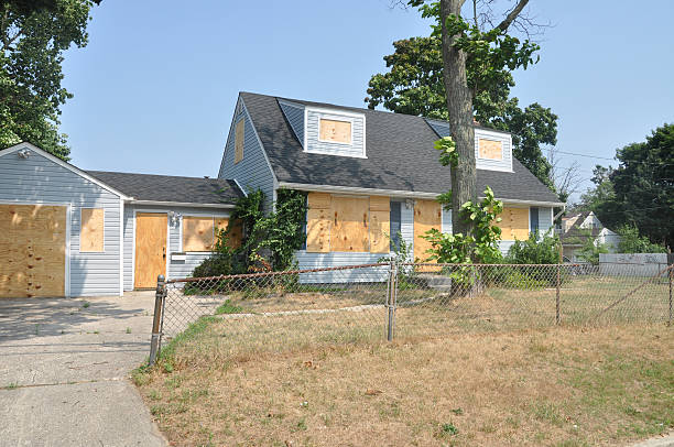 Abandoned Boarded Cape Cod Style Home stock photo