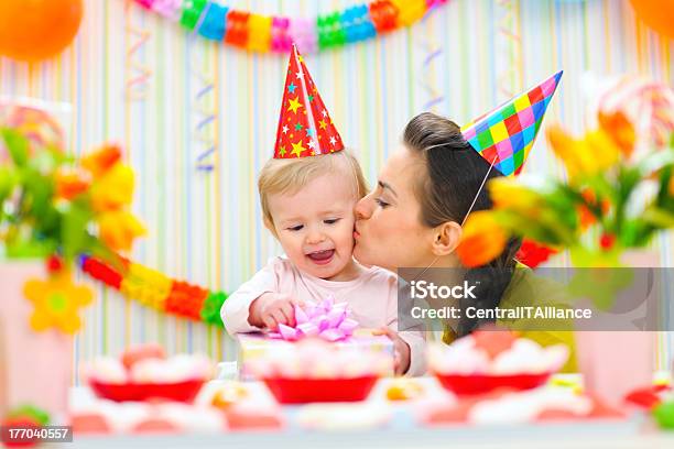 Mother Kissing Her Happy While Baby Checking Present Stock Photo - Download Image Now