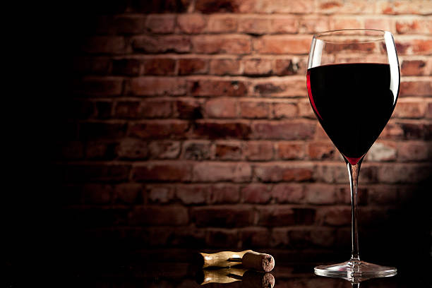 istock glass wine on the background of a brick wall 177040911