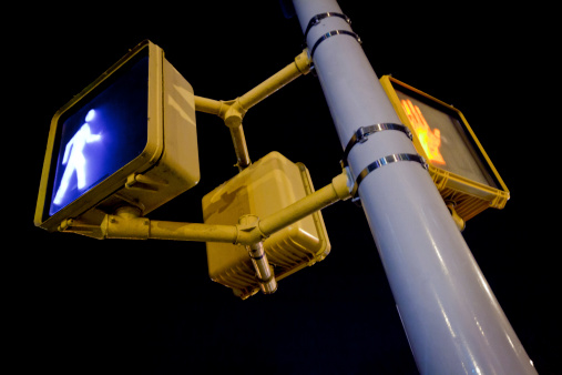 Amber traffic light, traffic arrow signs, street view. Lugo city, Galicia, Spain.