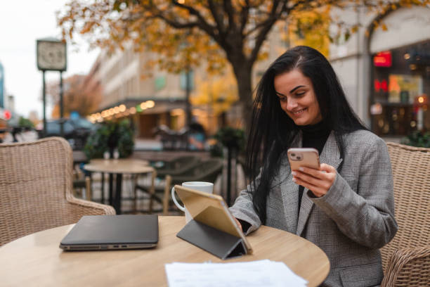 istock Young businesswoman working on her tablet and smartphone while sitting outdoors in a cafe 1770413656
