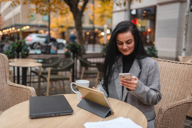 istock Young businesswoman working on her tablet and smartphone while sitting outdoors in a cafe 1770413685