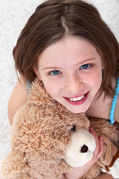 istock Young girl with teddy bear 177042179