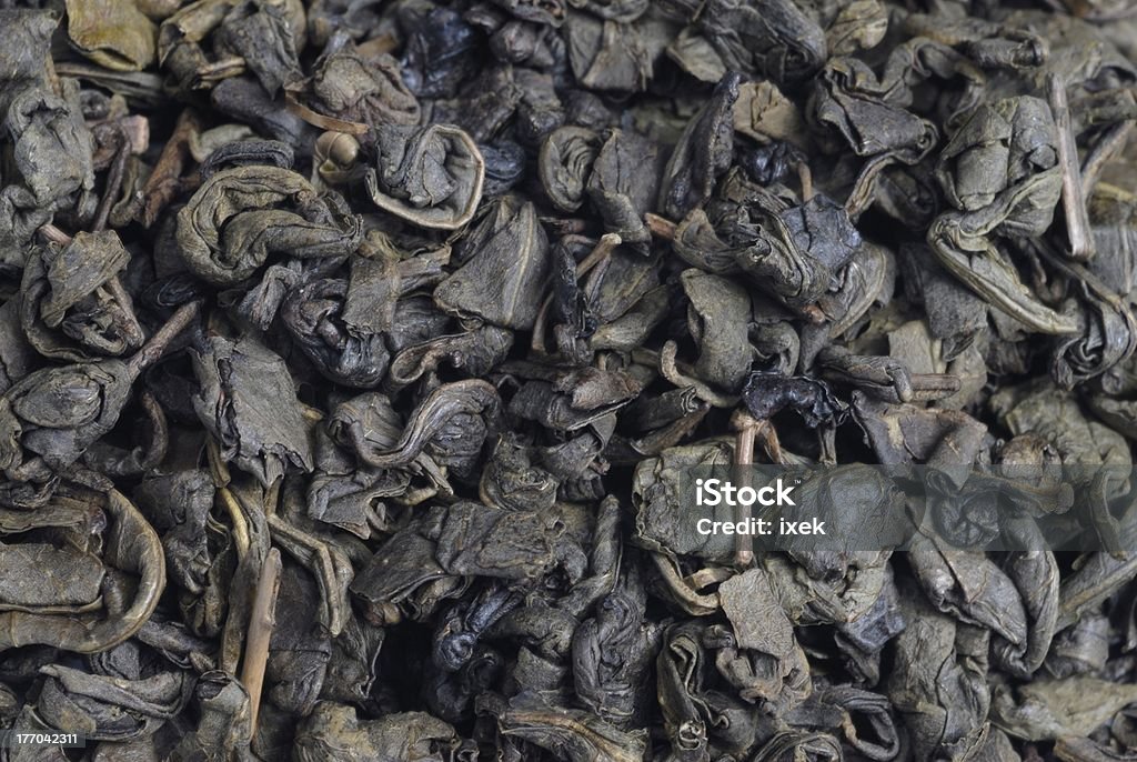 close up of green tea leafs close up of green tea leafs with no background Alternative Medicine Stock Photo