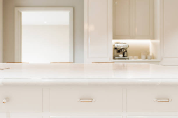 istock Kitchen white countertop with white marble, with blurred bokeh background. Presentation of goods in the kitchen interior on the countertop surface. 3D rendering 1770427673