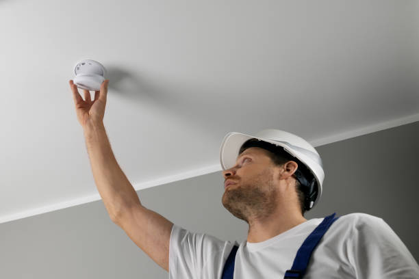 istock fire safety engineer installing photoelectric smoke detector on house ceiling. home security and fire alarm system 1770428343