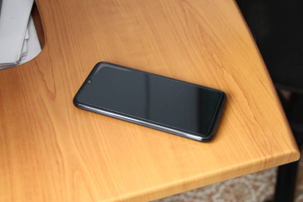 istock Smartphone lies on a wooden table 1770431043