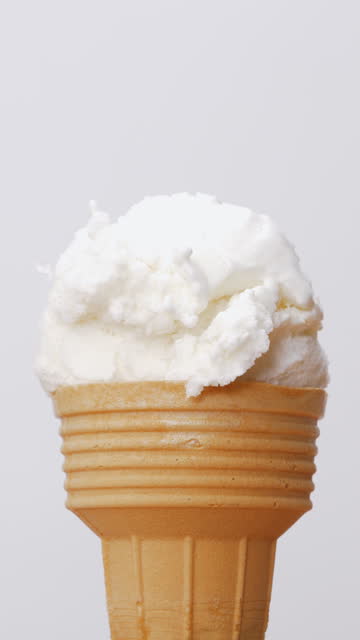 Scoop coconut milk flavored ice cream into the cone.