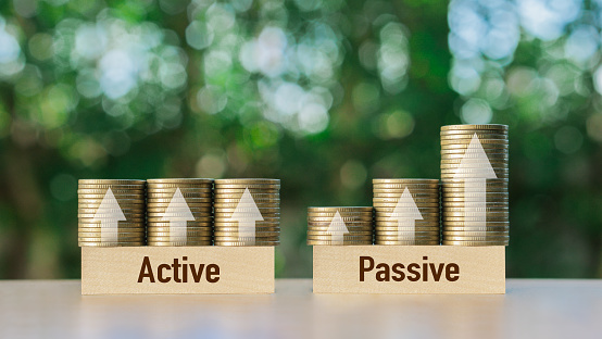Passive income and Active income on stack coins with arrow sign. Financial freedom concept.Investment business stock growth.strategy,future,profit.
