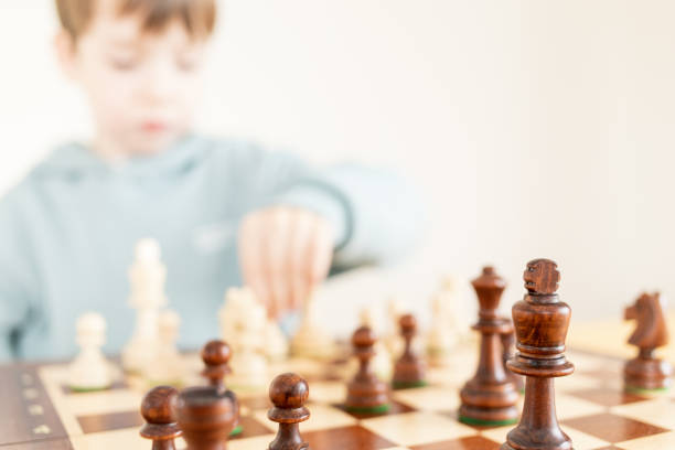 istock 6 year old boy plays chess 1770455264