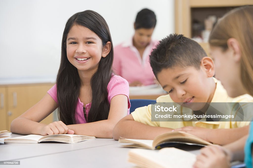 Group of elementary school pupils Group of elementary school pupils reading smiling Reading Stock Photo