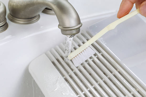 istock Hand cleaning fan vent cover in sink 177047779