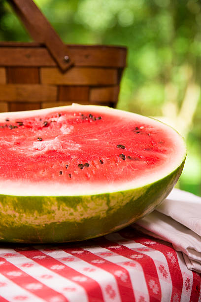 istock Food:  Fresh red ripe watermelon on traditional checked picnic tablecloth. 177047804