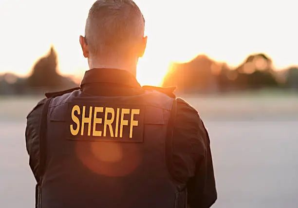 County Sheriff Police officer looks over the county while on duty.