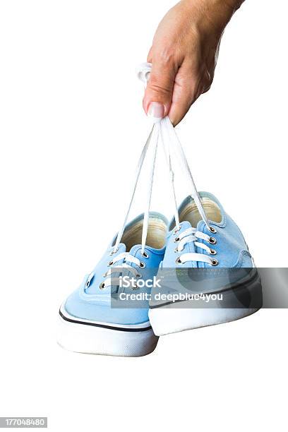 Woman Hand Holding Sneakers On White Background Stock Photo - Download Image Now - Activity, Canvas Shoe, Casual Clothing