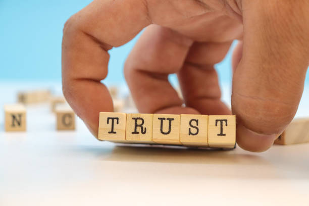 istock Hand Holding Trust Word On Wooden Cubes 1770529697