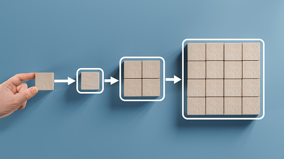 Business process, Workflow, Flowchart, Process Concept with wooden blocks on blue background. Hand holding wooden cube block arranging processing management.