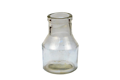 Small Vintage Victorian clear glass ink bottle isolated with a white background
