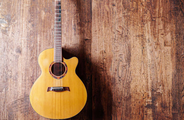 istock classical guitar on wooden background 1770537388