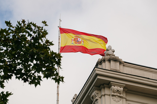 A large spanish flag on top of a building