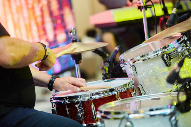 istock Male hands play with drumsticks on the drum set. 1770543424