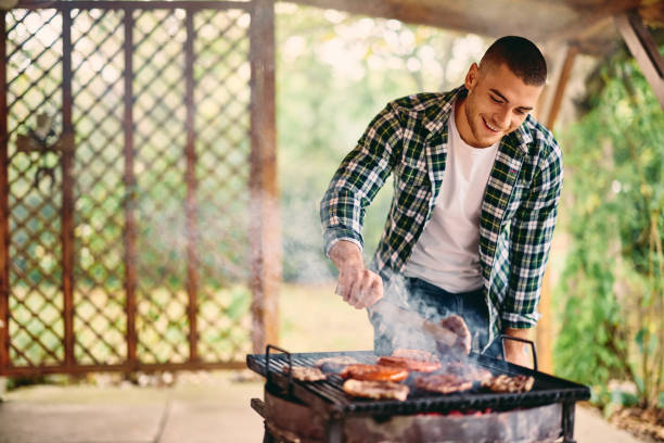 istock A happy man barbecuing outdoors, looking happy, enjoying himself alone. 1770550075