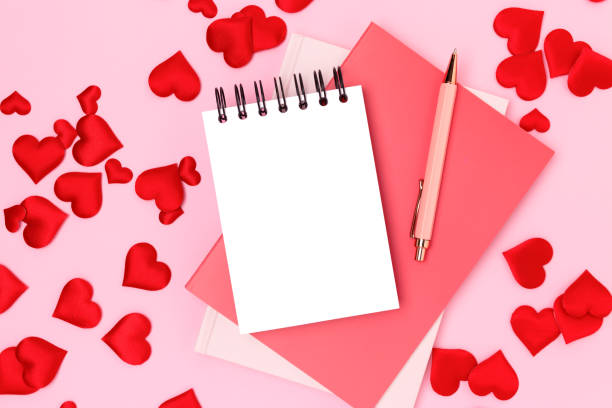 istock Empty notepad, pen and textile hearts confetti on a pink background. 1770550658