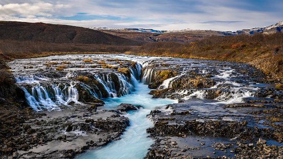 Images of the beautiful bruarfoss waterfall in Iceland. Turquoise blue water with multiple streams and flows.