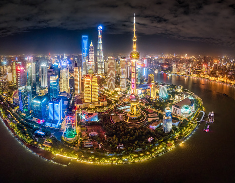 Aerial view of Lujiazui buildings illuminated at night in front of Huangpu river