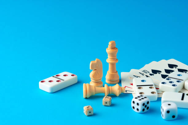 istock Items for playing chess, poker and domino on blue background studio shot 1770577677