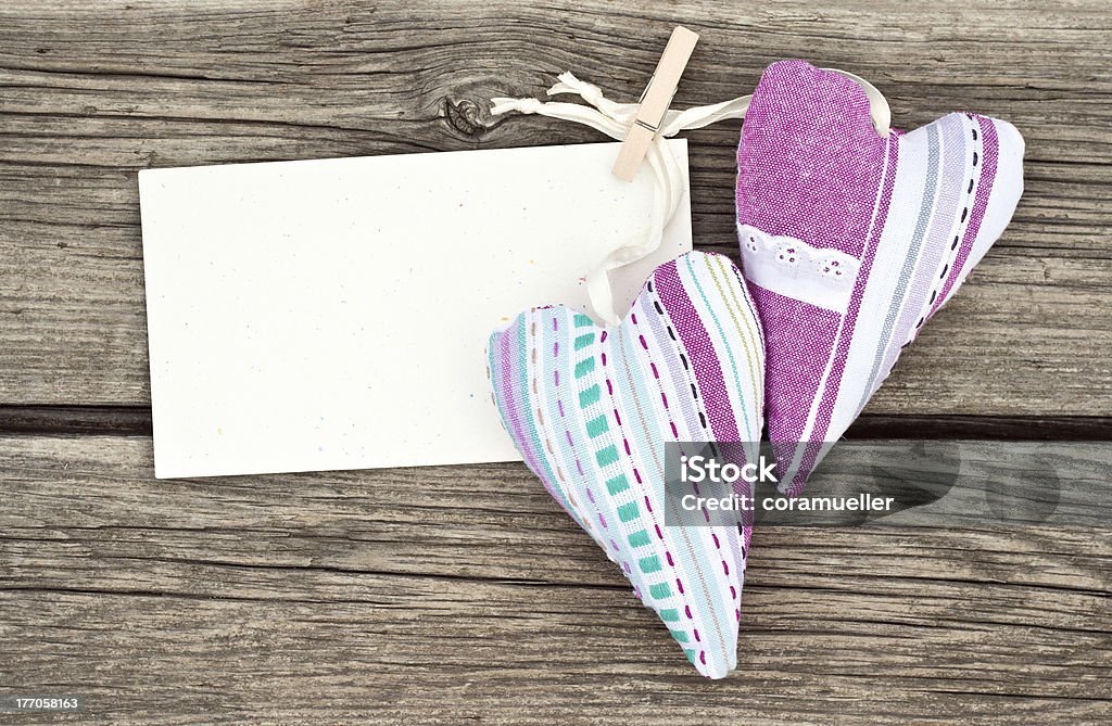 Two hearts hearts and card on wooden ground Birthday Stock Photo