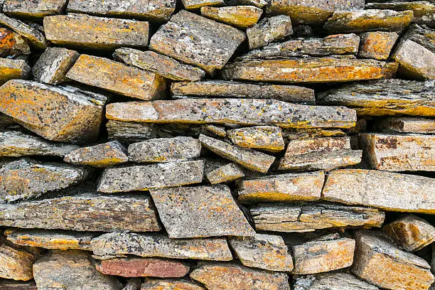 ancient natural stone wall pattern closeup.