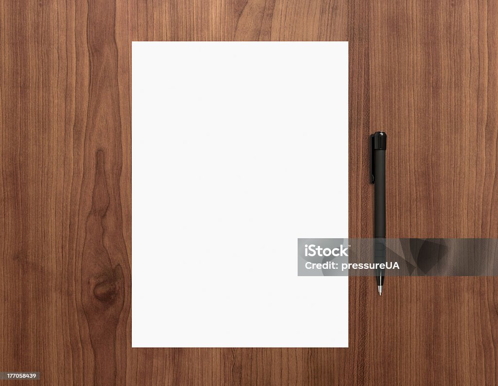 Blank paper with pen on desk Blank white paper with pen on a wooden desk. High quality graphic collage. Desk Stock Photo