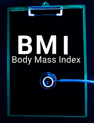 Body Mass Index term on blackboard with stethoscope. invert image.