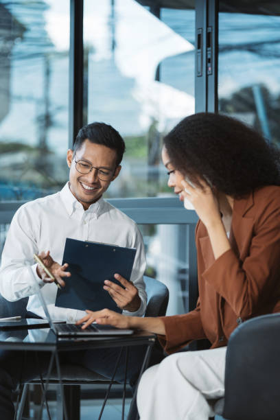 Business people talk mobile phones update tasks,  women milestones progress planning while working on laptop computers, online business,  teleworking concept.