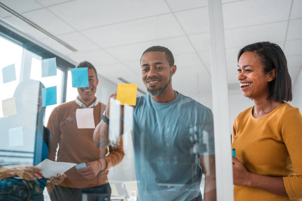 istock Mid-Adult Businesspeople Using Sticky Notes in Meeting 1770618398