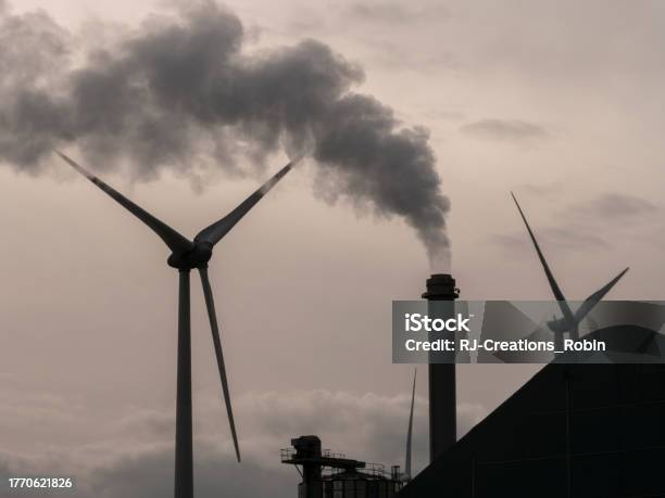 Smoke Pollution And Green Energy Windmill Turbine At The Same Time Stock Photo - Download Image Now