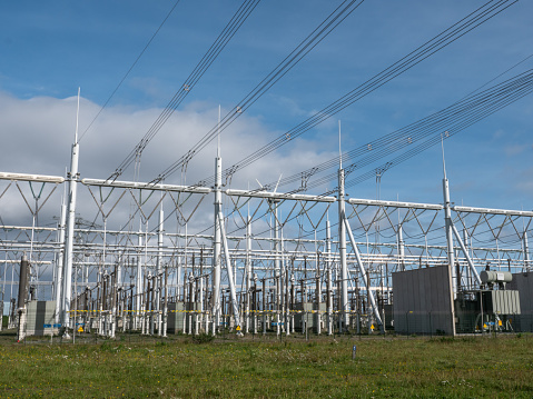 Delivery of electricity. High-voltage substation with power line and Insulator