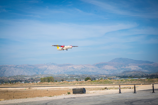 Radio controlled model airplane landing in the air on blue sky background.