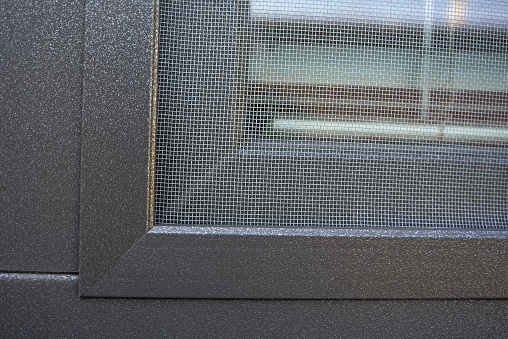 Detail on the mosquito mesh on a plastic window