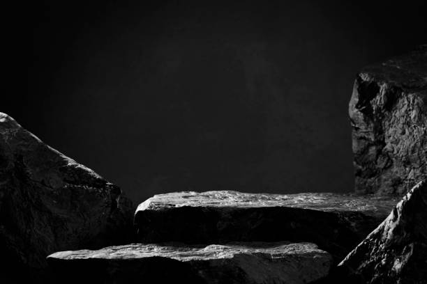 Black stone podium for luxury product placement. Black stone podium for luxury product placement. Rock granite pedestal stage background. Natural material scene. Minimal luxury aesthetic. marble rock photos stock pictures, royalty-free photos & images