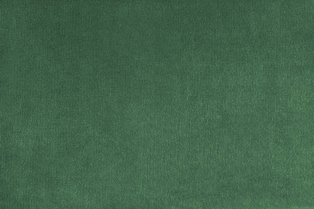 Plain green velours fleecy upholstery fabric texture background.